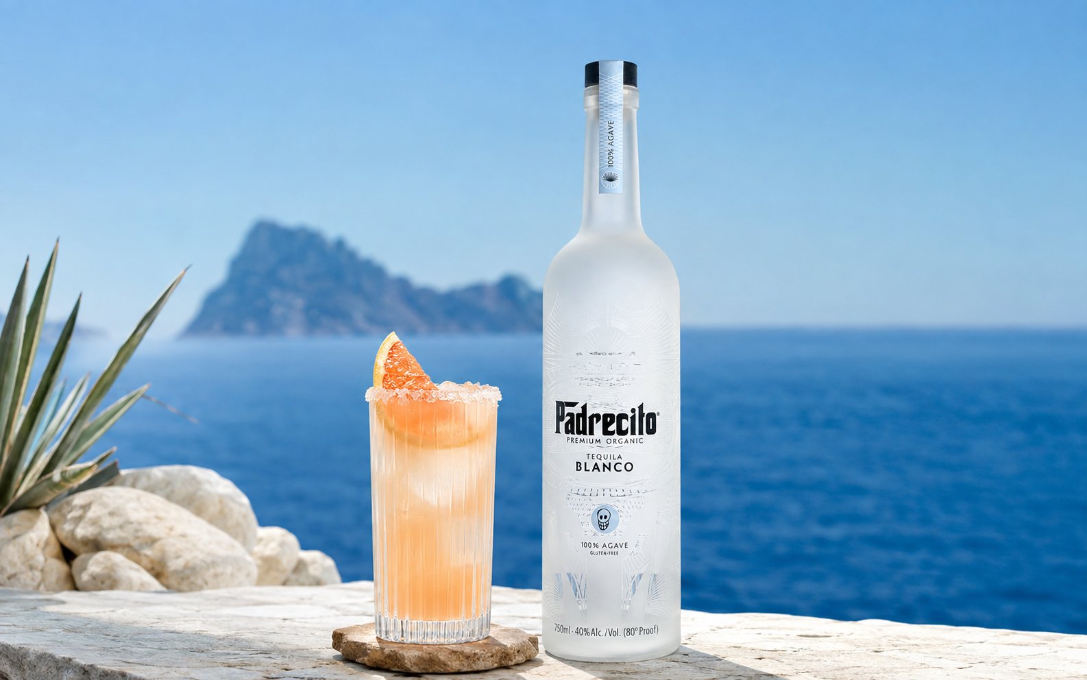 PadreLoma cocktail next to a bottle of Padrecito Premium Organic Blanco by the sea